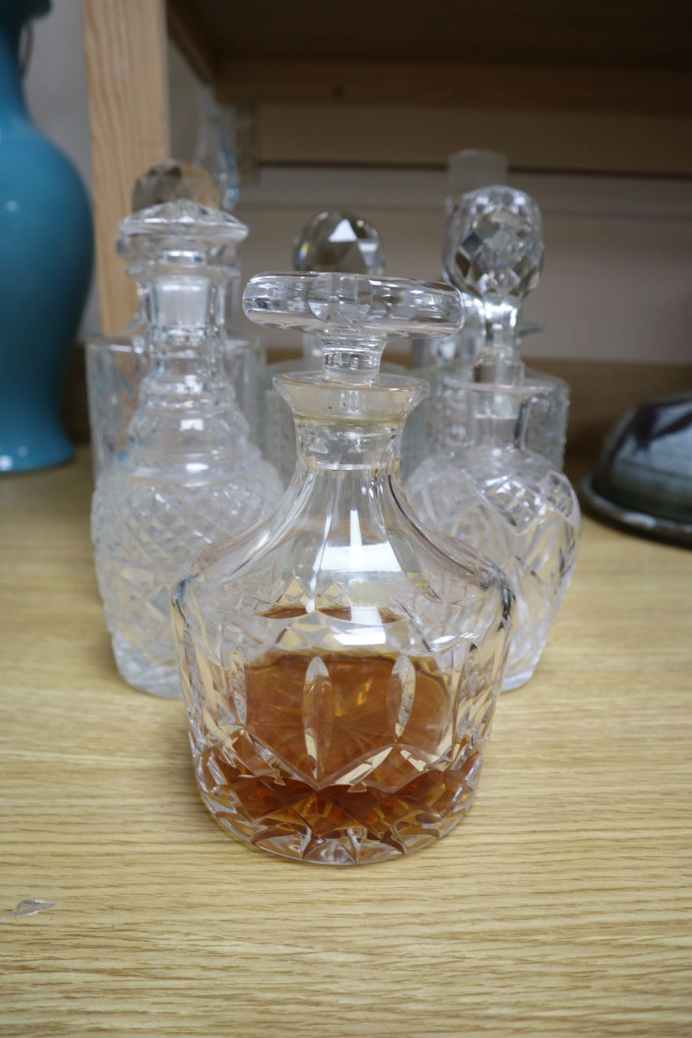 Nine various cut and mounted glass decanters and stoppers and two gin labels